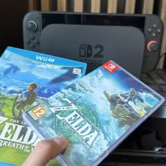 Dwie gry z serii Zelda: Breath of the Wild i Tears of the Kingdom, obok konsoli Nintendo Switch.