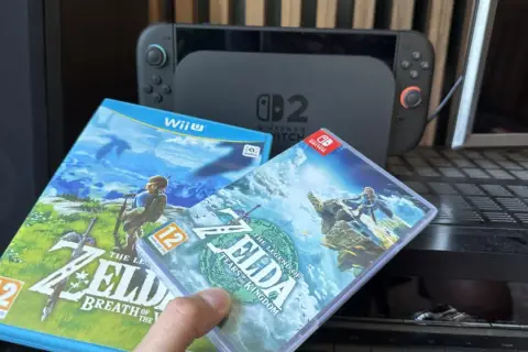 Dwie gry z serii Zelda: Breath of the Wild i Tears of the Kingdom, obok konsoli Nintendo Switch.