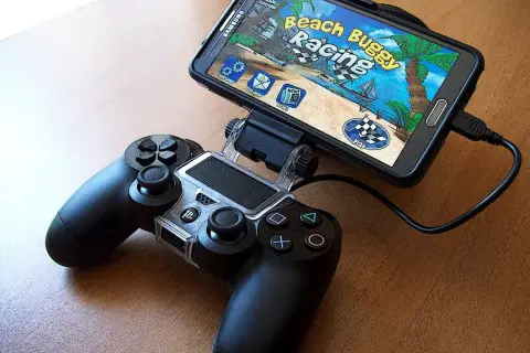 Smartfon z grą "Beach Buggy Racing" podłączony do kontrolera. Idealny zestaw do grania w top gry na androida.