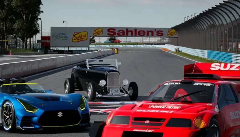 Trzy samochody wyścigowe na torze, w tym niebieski Suzuki, czerwony Suzuki i czarny hot rod. Grafika z gry Gran Turismo na PC.