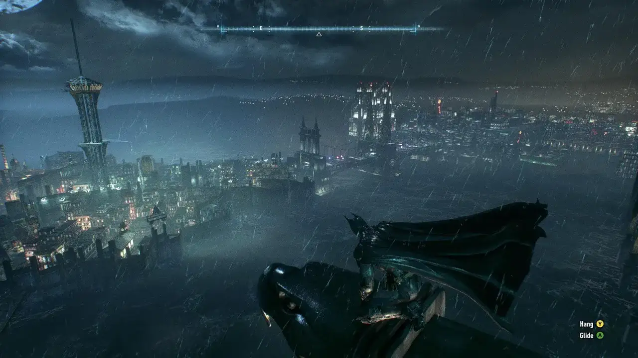 Batman w deszczowym Gotham, gotów do skoku. Widok na miasto z perspektywy nietoperza w grze Batman Arkham Origins.
